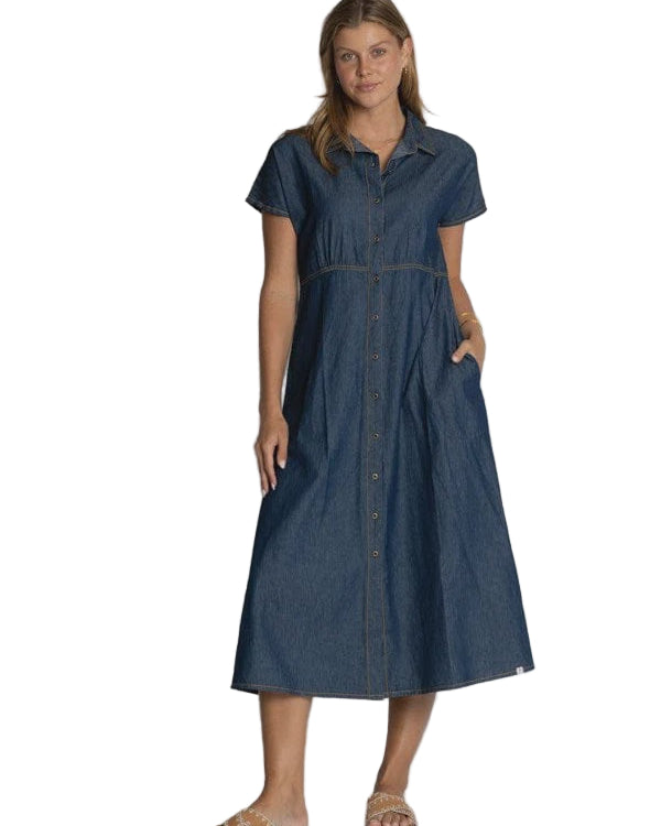 Woman wearing a blue denim dress against a plain background